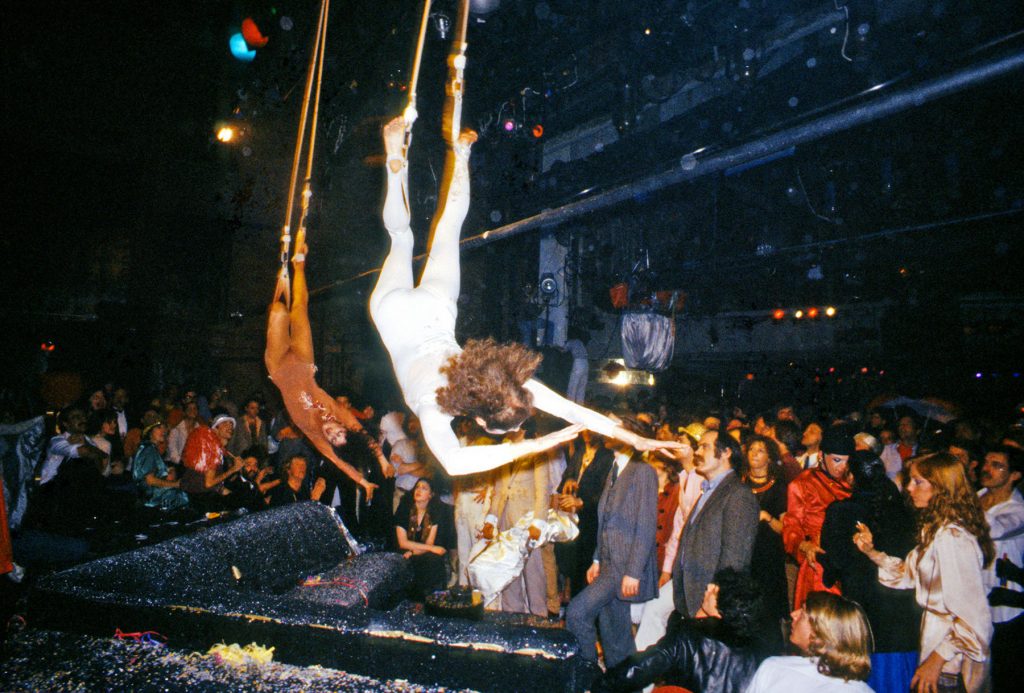 Acrobats descend from the rafters as part of a New Year's Eve party performance at Studio 54, New York, New York, January 1, 1978. (Photo by Allan Tannenbaum/Getty Images)