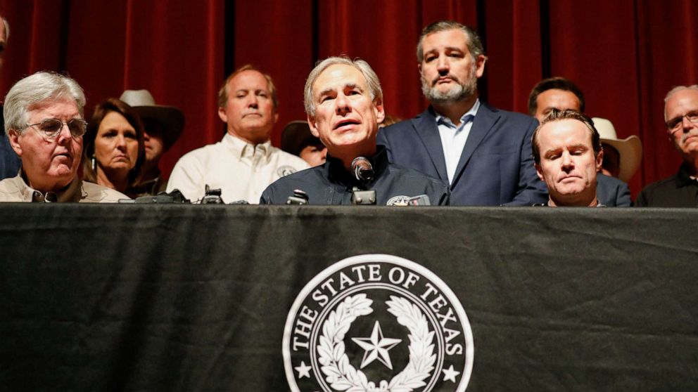 PHOTO: Texas Governor Gregg Abbott is accompanied by Senator Ted Cruz as he speaks to the media at Robb Elementary school, the day after a gunman killed 19 children and two teachers at the school in Uvalde, Texas, May 25, 2022. 